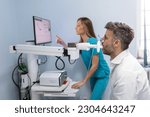 Small photo of Man performing pulmonary function test and spirometry using spirometer at medical clinic. Spirometry of lungs