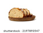 Traditional Homemade Sliced Bread on Wooden Plate Isolated. Brown Organic Cereal Bread Pieces, Round Loaf Slices on White Background Side View