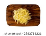 Small photo of Raw grated potato on wooden cutting board background. Grate and sliced potatoes pile for swiss potato or pancakes on vintage chopping board closeup