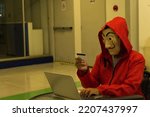 Small photo of BANGKOK, THAILAND - May 25, 2022 : Fans of the series Money heist (La Casa De Papel) wearing costumes with Dali face mask from the Spanish,Money heist Korean Netflix series 2022