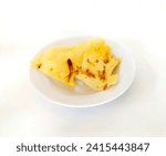 Small photo of Rempeyek or fish crackers on white plate with salt fish or ikan teri isolated on white background. Fried savory Javanese crackers made from rice flour with salted fish by crispy flour mixture.