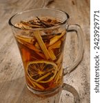 Small photo of Wedang uwuh is Javanese herbal drink consists of ginger, cloves or clove sticks, clove leaves, dry cinnamon leaves, dry nutmeg leaves, secang wood shavings, cardamom, and lump sugar or honey.