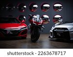 Small photo of Shanghai, China- February 16, 2023: A red Acura NS, a white LB modified Nissan GT R sportcars and a red DUCATI Superleggera motorbike are parked in showroom