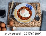 Small photo of Pisto Manchego (Manchego ratatouille) with fried egg ingredients, red and green peppers, onion, courgette, and eggs. Concept typical and traditional food of Spain. Horizontal photo and selective focus