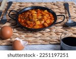 Small photo of Pisto manchego (Manchego ratatouille) with red and green peppers, courgette and onion. Red wine and eggs. Typical and traditional Spanish food. Horizontal photo and selective focus.