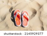 a pair of flip flops on the... | Shutterstock . vector #2145929377