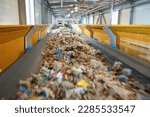 Small photo of Transportation of fuel obtained from waste (RDF) on a belt to the boiler for combustion. Fuel conveyor. Processing of municipal solid waste into an energy source.