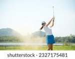 Small photo of Golfer sport course golf ball fairway. People lifestyle woman playing game golf and hitting go on green grass river and mountain background.  Asia female player game shot in summer.  Healthy Sport