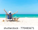 Summertime Vacation. Young girl asian woman relaxing and happy outdoors beach chair out with cocktail coconut juice in holiday summer blue sky background.  Travel and lifestyle Concept