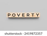 poverty wooden cubes on gray background