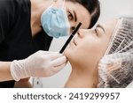 Small photo of Beautiful young woman getting cosmetology treatment facial skin injection by doctor beautician. Perfect facial proportions after injections. Face correction