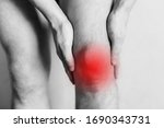 Small photo of Joint injuries, fatigue at work. Area of the injury, the image on a clean background. Spasm on the man's knee.