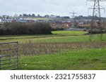Urban meets rural in the form of a new housing estate encroaching on farmland near Exeter, UK. Development of such rural sites has become a controversial issue in the country