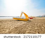Row Of Yellow Pedal Boats With...