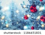 Border winter nature christmas background with frozen spruce, glitter lights, bokeh, snow. View through white frost pine branch. Happy new year. Text space. Elements of this Image Furnished by NASA