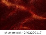 Small photo of Various stains and overflows of gold particles with burgundy tints. Beautiful flying shiny golden particles on a red background. Magic Galaxy of golden dust particles in red fluid.