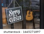 Sorry we're closed sign. grunge image hanging in cafe front