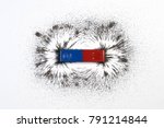 Red and blue bar magnet or physics magnetic with iron powder magnetic field on white background. Scientific experiment in science class in school.
