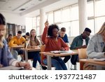 Small photo of Happy African American student raising her hand to ask a question during lecture in the classroom.