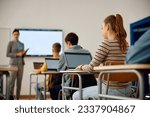 Female high school student learning coding on laptop during computer programing class in the classroom.