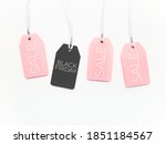 Pink and black tags on white background. Glamorous labels on silver threads. Black Friday sale and shopping. Top view, flat lay.