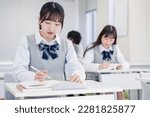 Small photo of High school students concentrating and taking notes