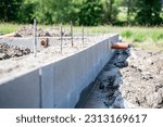 construction of house foundations - foundation strips with reinforcements and sewerage preparation, new house construction, rough construction
