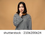 Small photo of Portrait of thoughtful upset girl pondering serious issues, looking with uncertain hesitant expression, making difficult choice. Indoor studio shot isolated on beige background
