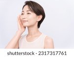 Small photo of Beauty portrait.Asian woman is touching her cheek.