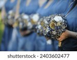 close up of bridesmaids holding flower bouquets with defocus background
