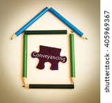 Small photo of A house symbol make from color pencil and puzzle with word conveyancing.