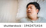 Small photo of Asian man sleeping on bed with snore face.Concept of snoring.Healthcare medical.Sleep health.Indian man sleep at home.Dream, rest, bed, tired father dad day.Sleep Apnea, Sleep Disordered Breathing.Sdb