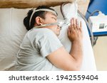 Small photo of Asian fat man wearing Cpap mask sleeping in bed, snoring man.Obstructive sleep apnea therapy. Cpap therapy, medical health, Sleep test, Good sleep, Machine, Patient, Sleep Disordered Breathing.Sdb