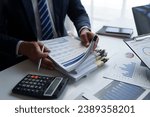 Small photo of Asian male financial officer or accountant checking investment results Financial budget analysis Planning to summarize results and report to the meeting Audit concept and investment results.