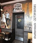 Small photo of Paris, France June 2018, Chez Edouard has a painted mural at kitchen door, with terrace busy by eight for coffee and croissants with regular clients reading newspapers and smoking cigarettes.