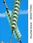 Small photo of High-voltage electrical insulator electric line against the dark blue sky (photographed with considerable approach on a focal length 400mm)