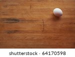 A Single White Egg Sits On A...