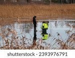 two men are fishing on the thin ice of a frozen lake. Thin ice, life-threatening 