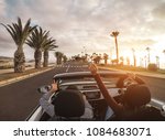 Happy people having fun in convertible car in summer vacation - Young couple laughing on cabrio auto outdoor - Travel, youth lifestyle, holidays and wanderlust concept