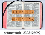 Small photo of Vancouver, BC, Canada - Circa May 2023: Scrabble letters spelling Bible Verse John 19:6 Crucify Crucify