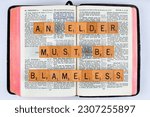 Small photo of Vancouver, BC, Canada - Circa May 2023: Scrabble letters spelling Bible Verse Titus 1:6 An elder must be blameless