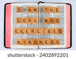Small photo of Vancouver, BC, Canada - Circa Dec. 2023: Scrabble letters spelling Bible Verse Jeremiah 9:24 I am the Lord who exercises kindness
