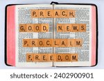 Small photo of Vancouver, BC, Canada - Circa Dec. 2023: Scrabble letters spelling Bible Verse Luke 4:18 Preach good news, proclaim freedom