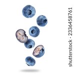 Small photo of Ripe whole and sliced blueberries close up in the air on a white background