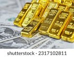 Small photo of Gold bar lean against each other on the USD bills. Gold is hard commodity good, risk asset, tangible value that used to be gold reserve, and fund reserve. safe assets during war and economic crisis.