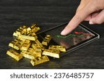 Small photo of Gold bar on calculator with trading line graph for calulate the gold price. Gold is hard commodity , risk asset, tangible value that used to be gold reserve, save assets during war and economic crisis