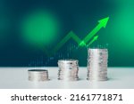 Coins stack of money on saving, the step of the financial stock market, graph and rows of coins, business investment on a green background, Economy stock market growth of financial recovery.