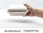 Hand holding paper food box made from natural plant fiber food box on white background concept for food delivery 