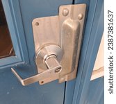Small photo of heave steel commercial door with lever handle and latch guard plate for protecting against break ins or forced entry.