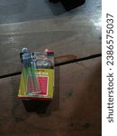 Small photo of November 10, 2023 Mojokerto, Packaged cigarettes and lighters thereon